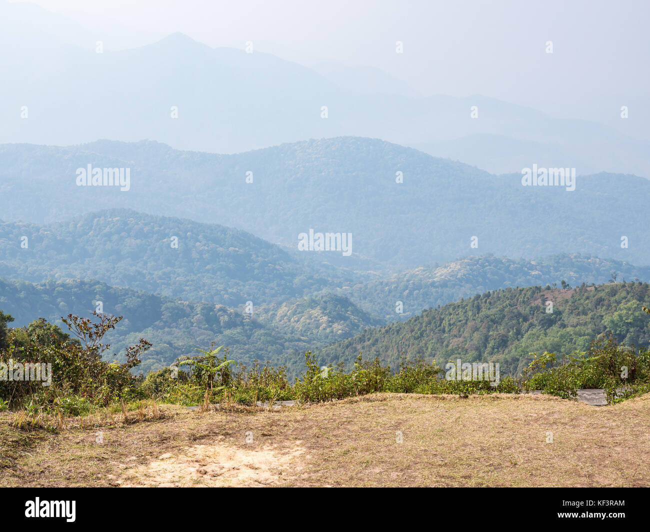 Camping field on the top of the high mountain with the light fog in the morning. Stock Photo
