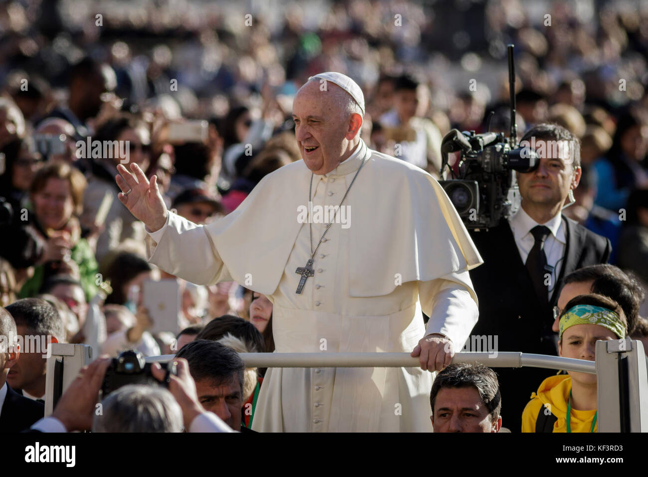 Pope Francis rides on the Popemobile through the crowd of the faithful ...