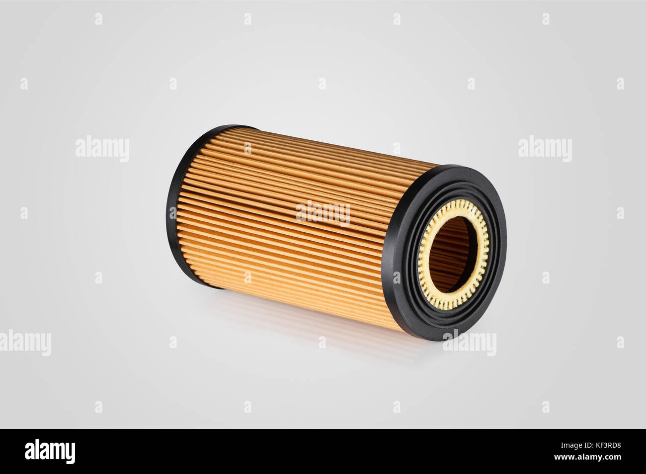 automotive filter cylindrical shape of orange color on a white ...