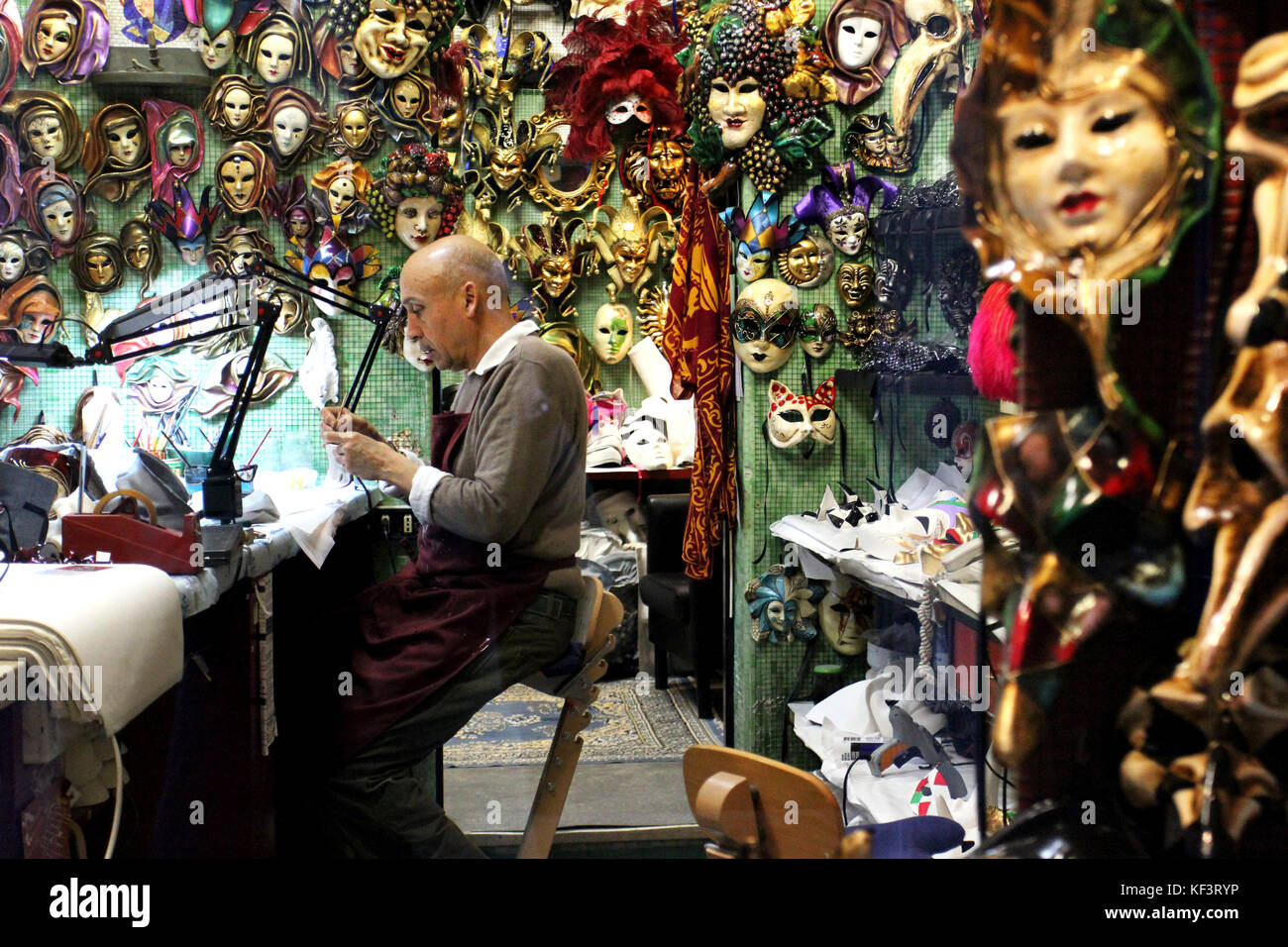 Artist working in mask shop, Venice, Italy, Europe. Stock Photo