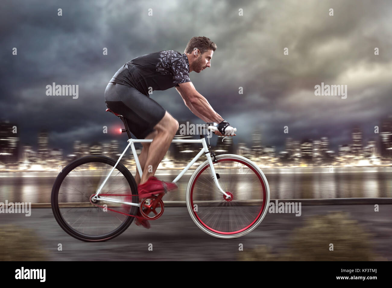 Cyclist cycling in front of a nightly skyline Stock Photo