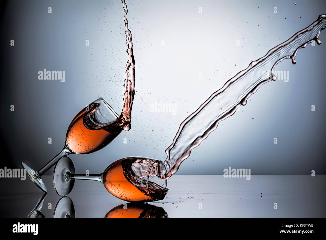 The movement of sliding one wine glass filled with wine into another one. Stock Photo