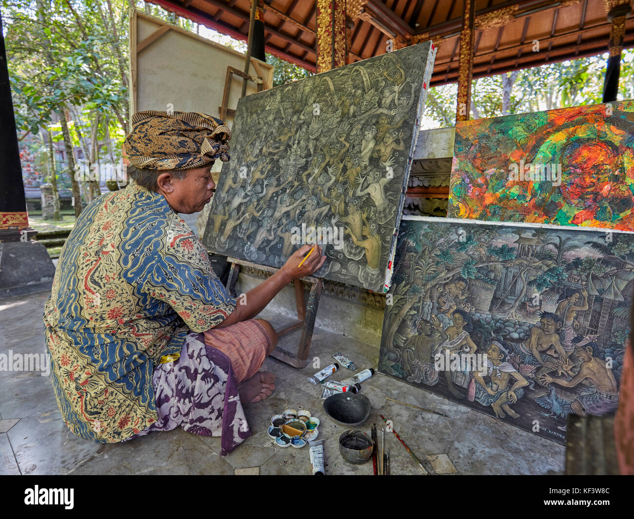 Local artist working at the Agung Rai Museum of Art (ARMA). Ubud, Bali, Indonesia. Stock Photo