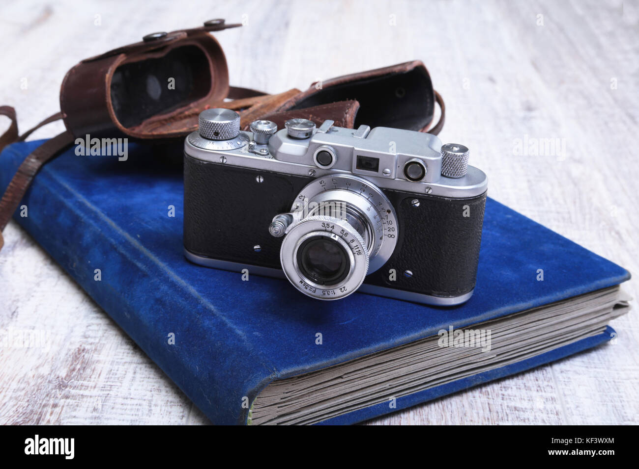 Vintage old film photocamera in leather case and album Stock Photo Alamy