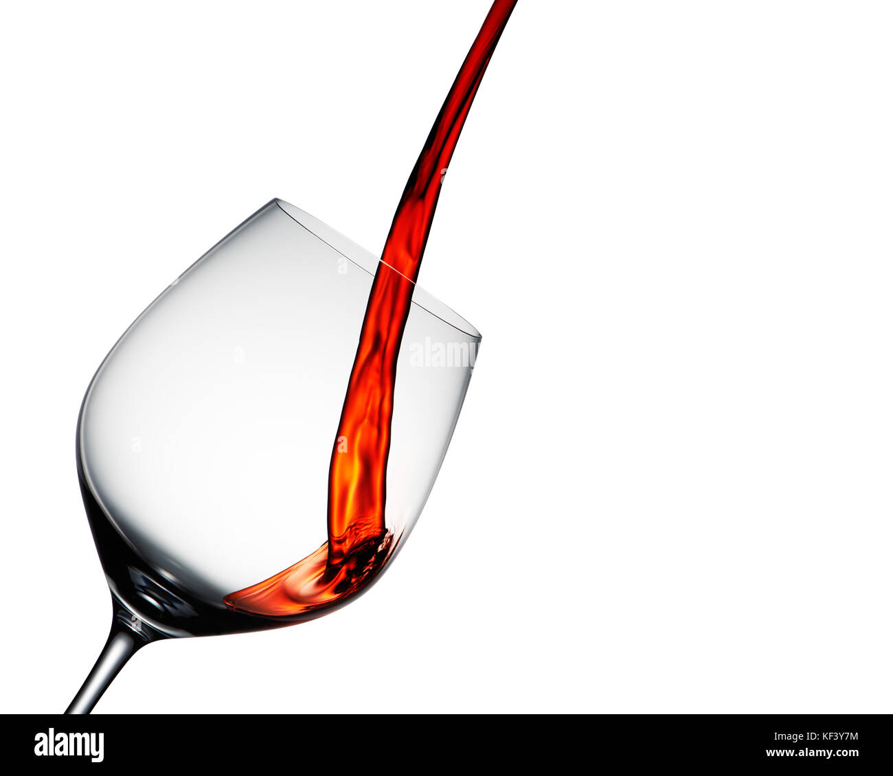 Red wine poured into elegant wine glass isolated on white Stock Photo