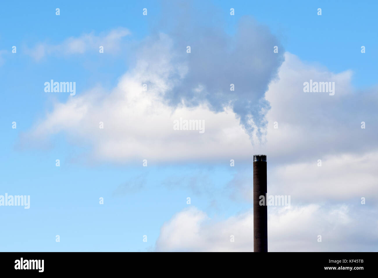 Smoking industrial chimney and beautiful sky with clouds Stock Photo