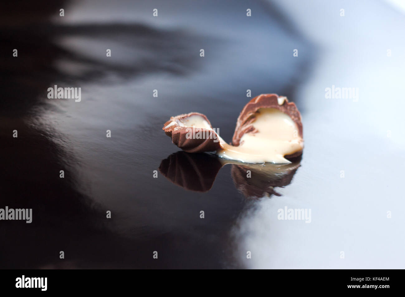 Chocolate candies filled with creamy on black background Stock Photo