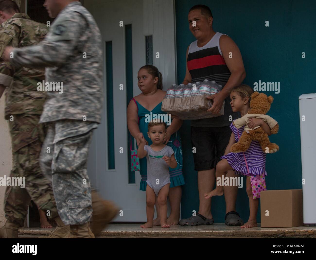 U.S. Army soldiers deliver emergency supplies to stranded Puerto Rican residents in the aftermath of Hurricane Maria October 9, 2017 in Indiera Baja, Puerto Rico. The residents were isolated due to landslides and flooding. Stock Photo