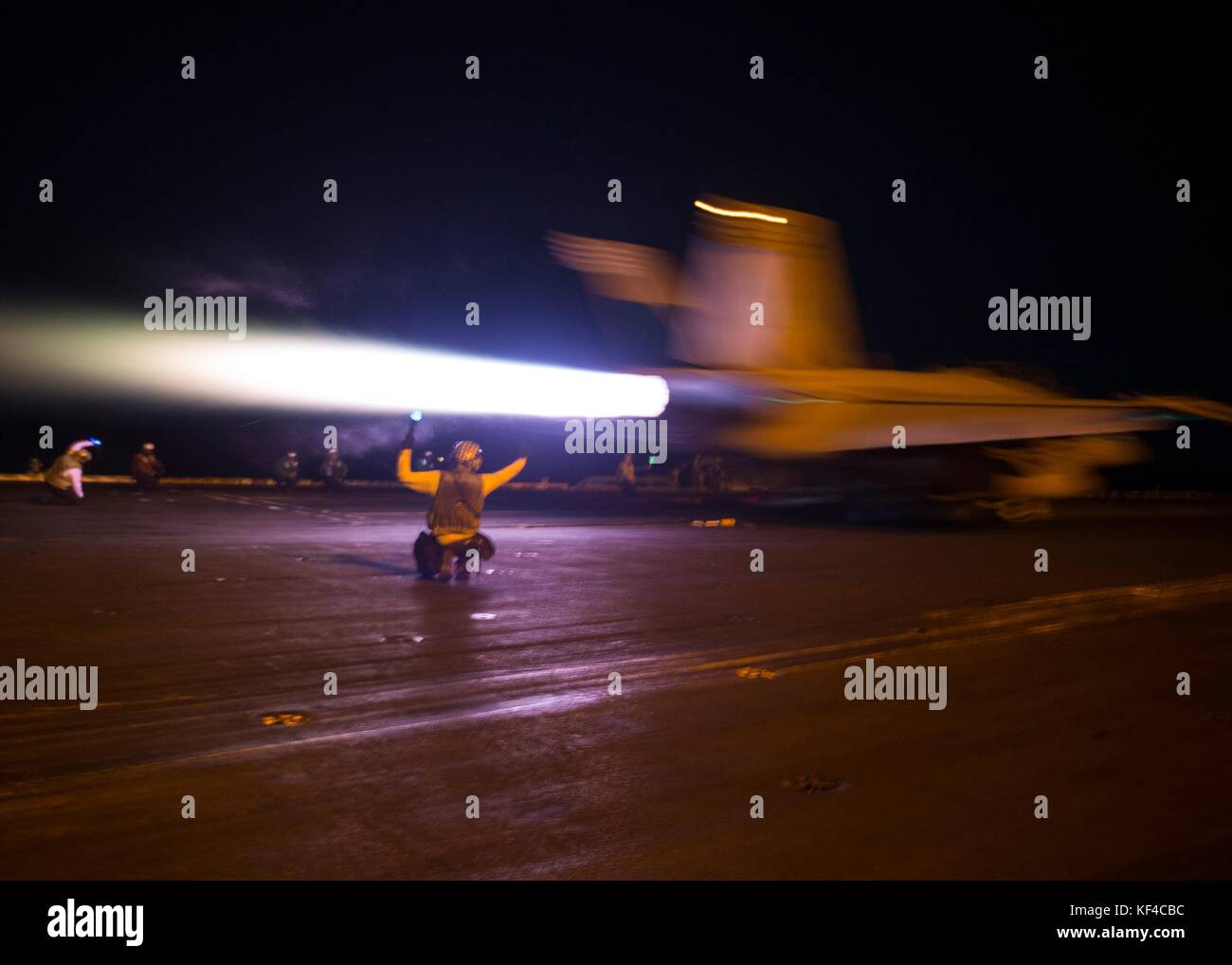 A U.S. Navy F/A-18F Super Hornet jet fighter aircraft launches off the flight deck of the U.S. Navy Nimitz-class aircraft carrier USS Nimitz at night October 5, 2017 in the Arabian Gulf. Stock Photo
