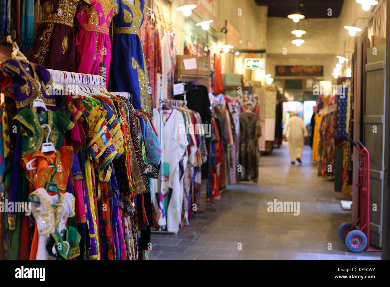 Colorful eastern dresses displayed outside a shop on the warren of covered lanes in Souq Waqif, Doha, in October 2017. Stock Photo