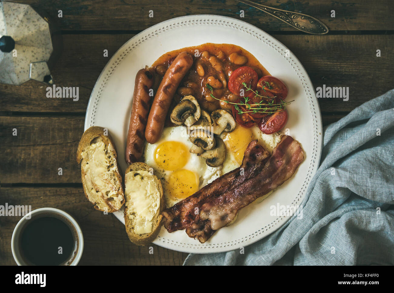 English breakfast with fried eggs, sausages, mushrooms, bacon, beans