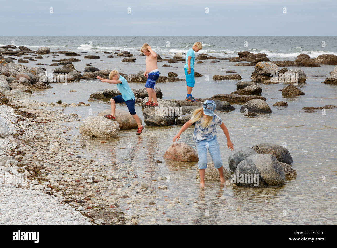 Kids playing at the water and rocks at Gotland south east coast Stock Photo