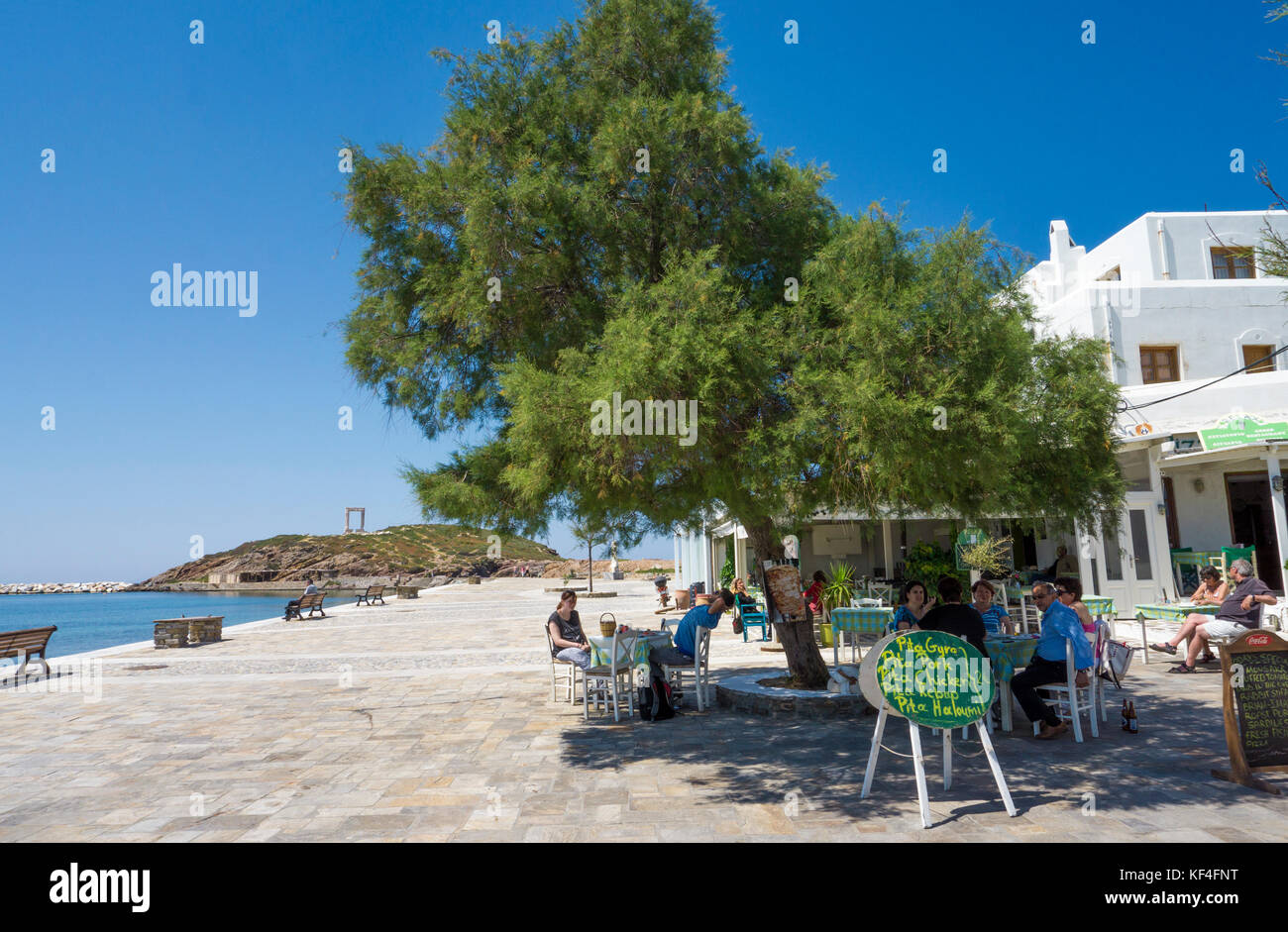 People at beach coffee shop close the harbour, Naxos-town, Naxos, Cyclades, Aegean, Greece Stock Photo