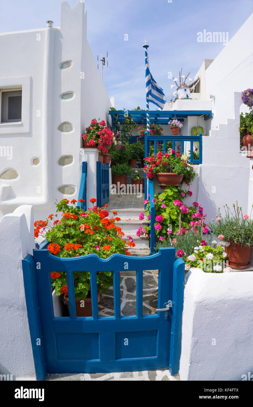 Flower decorated house with greek national flag at Naxos-town, Naxos, Cyclades, Aegean, Greece Stock Photo