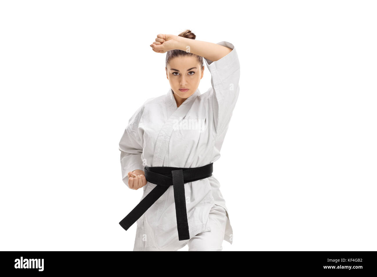 Girl in a kimono doing a karate kata isolated on white background Stock Photo