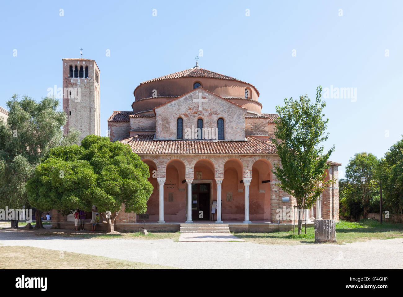 The 11th Century Church of Santa Fosca on Torcello Island, Venice,  Veneto, Italy in the North Lagoon built in the form of a Greek cross. The Campanil Stock Photo