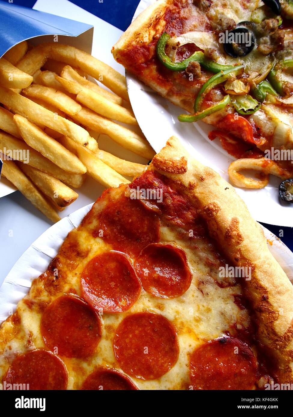 Photo of slices of pizza on a plate and french fries Stock Photo Alamy