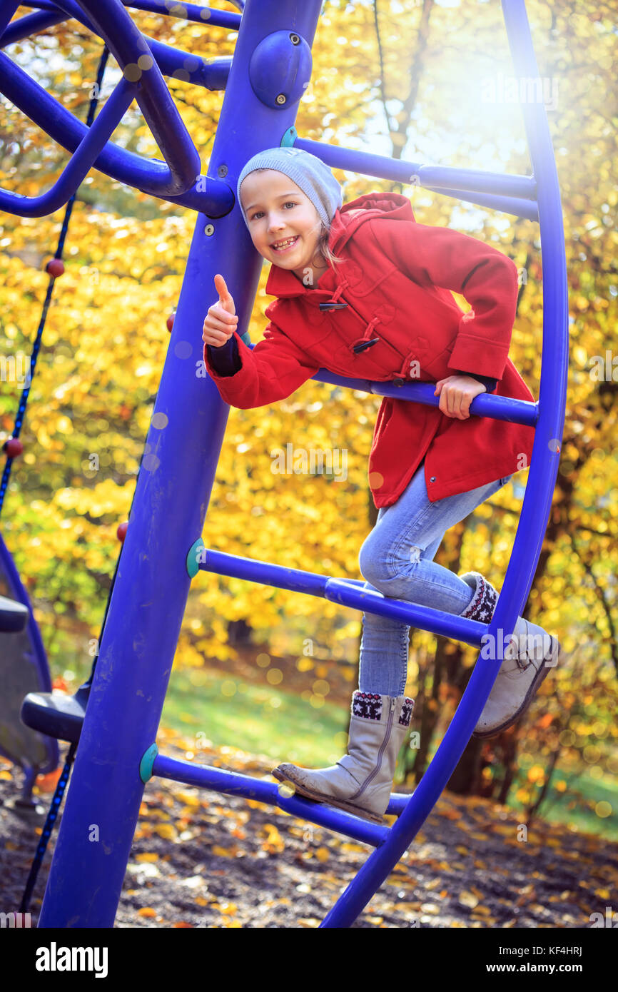 little girl playing on playground in the park Stock Photo - Alamy