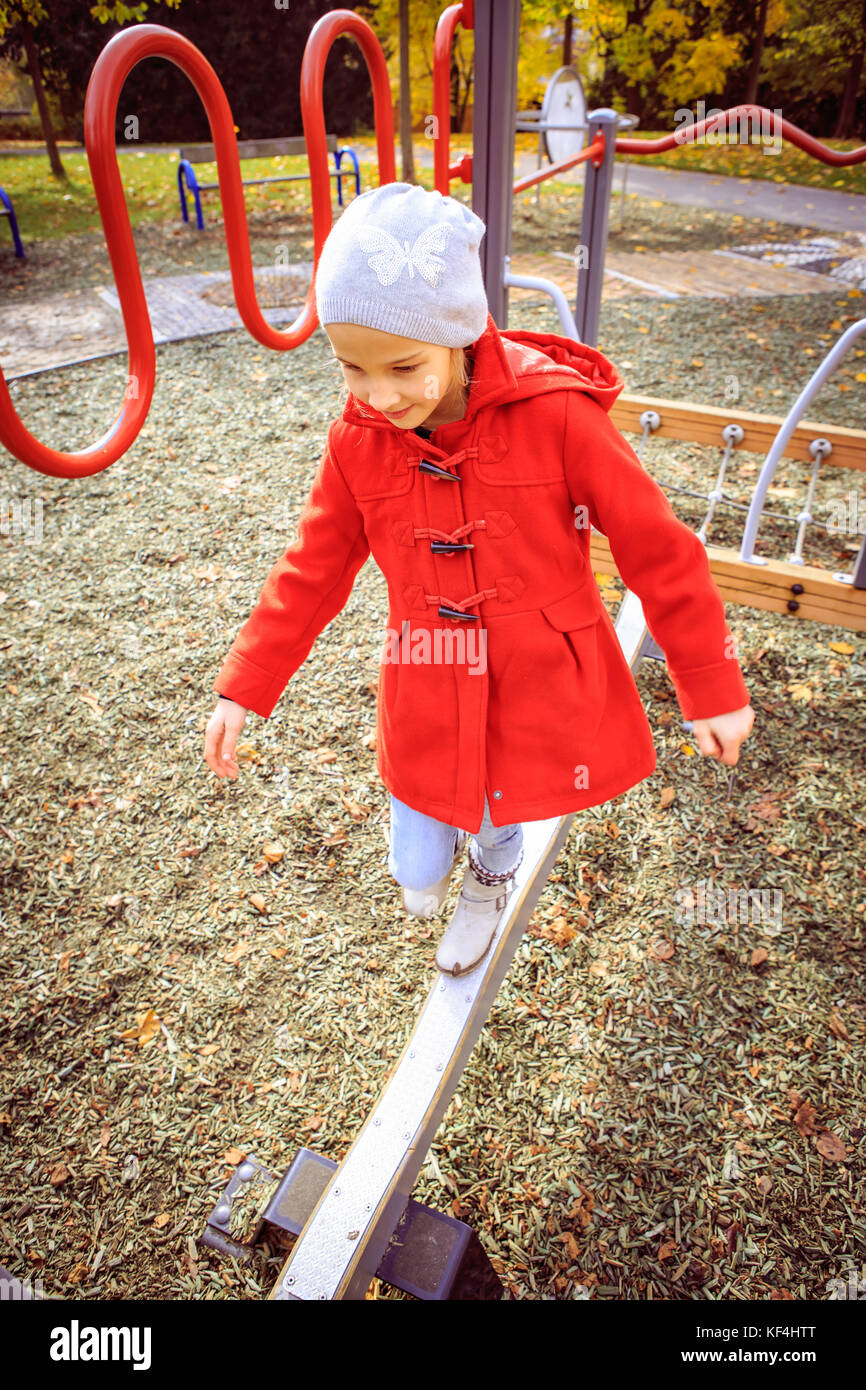 little girl playing on playground in the park Stock Photo - Alamy