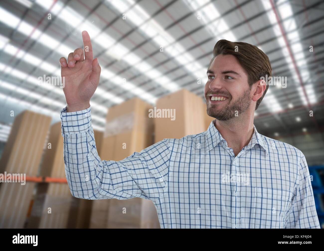 Digital composite of Businessman touching air in front of warehouse Stock Photo