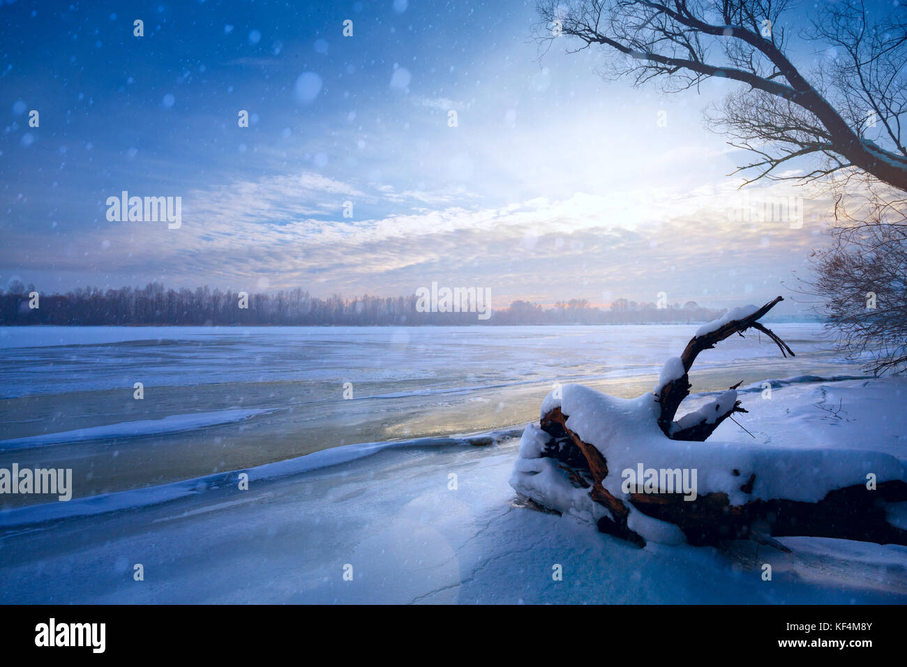 winter landscape panorama; sunset on the bank of a frozen river; ice ...