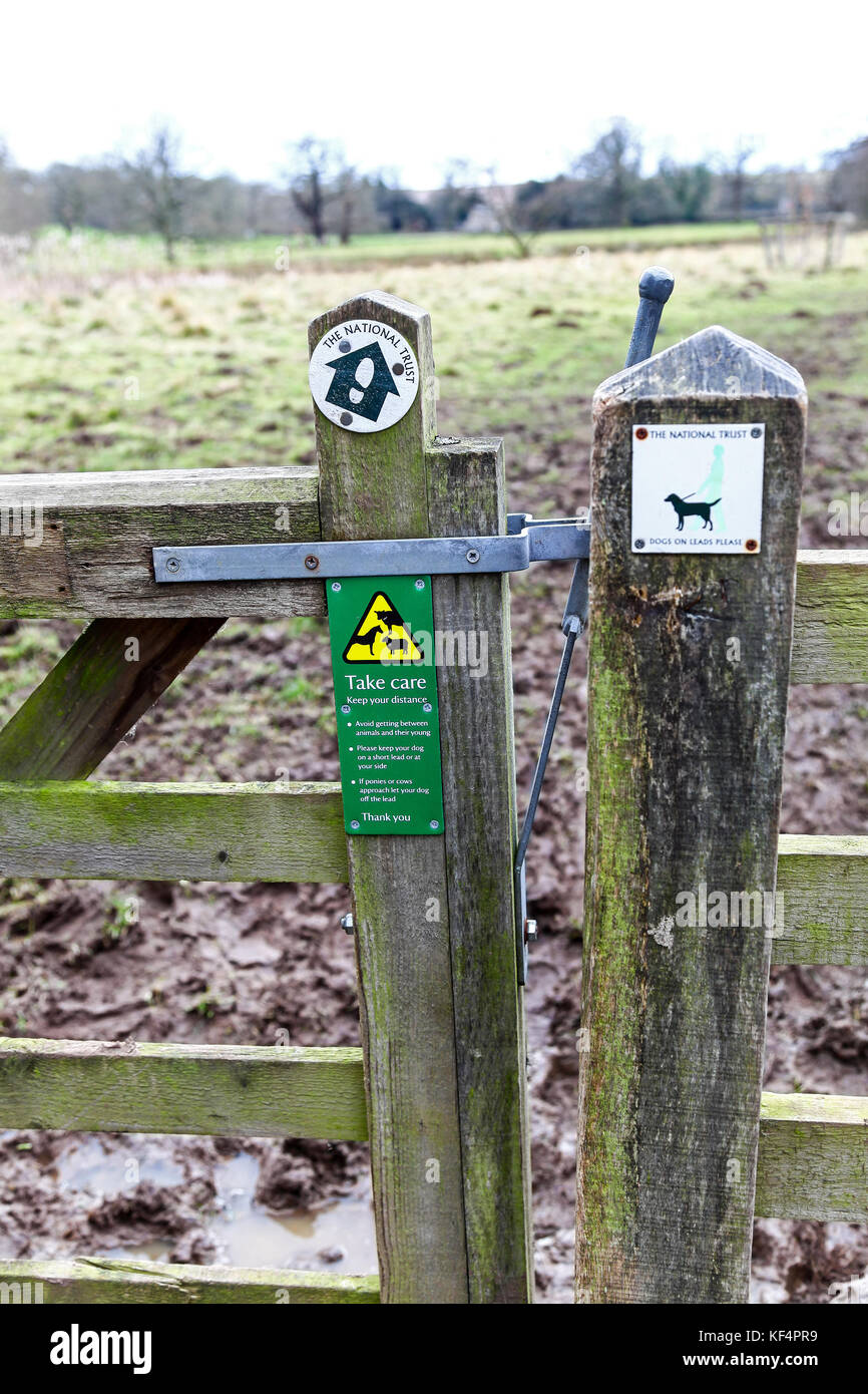 A sign on a gate at Kedleston Hall, Kedleston, Derbyshire, England, UK saying take care, keep your distance from the farm animals Stock Photo