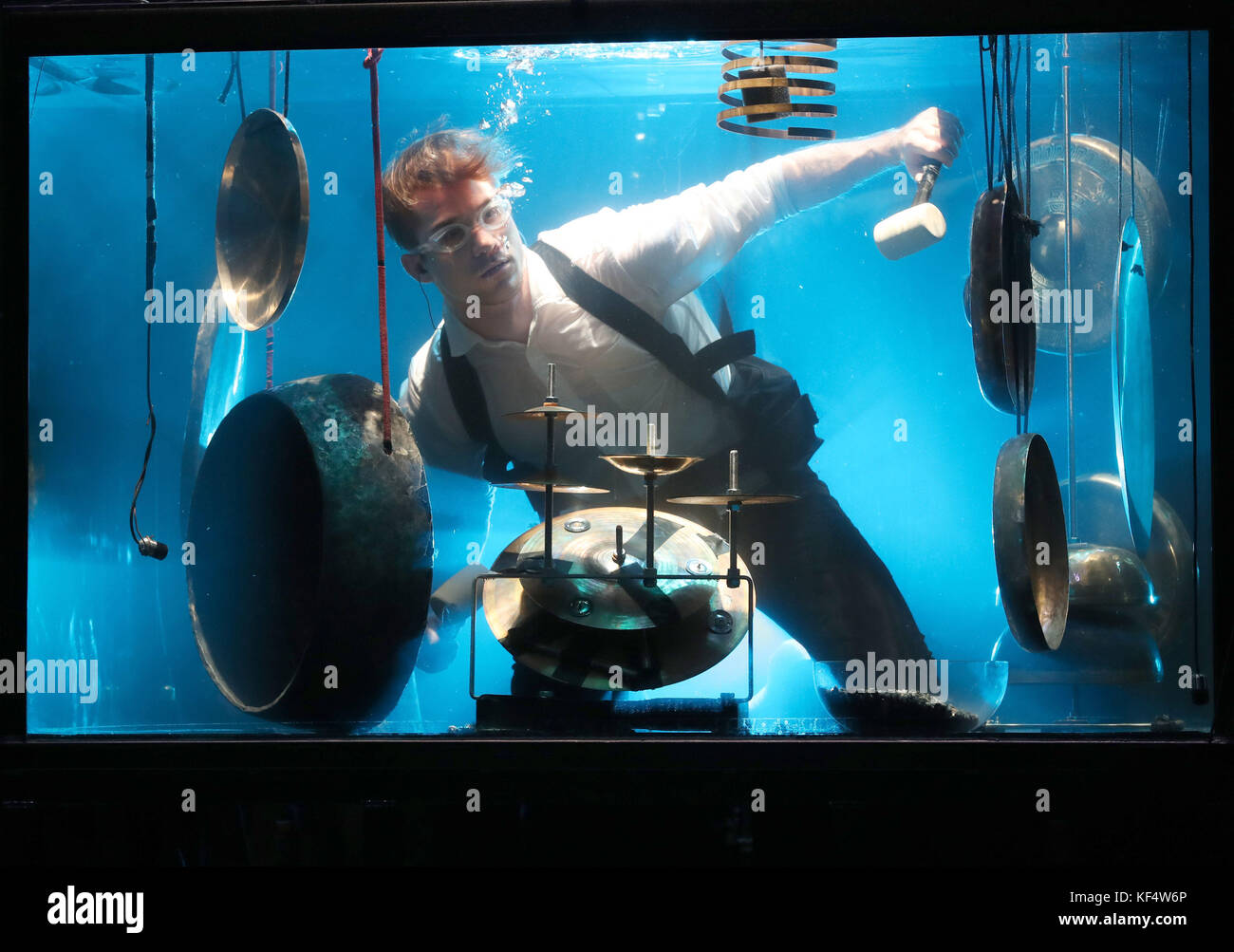 Percussionist Morten Poulsen, a musician with Danish company Between Music, plays underwater in a tank during a rehearsal ahead of their UK premiere concert Aquasonic at the Tramway in Glasgow. Stock Photo