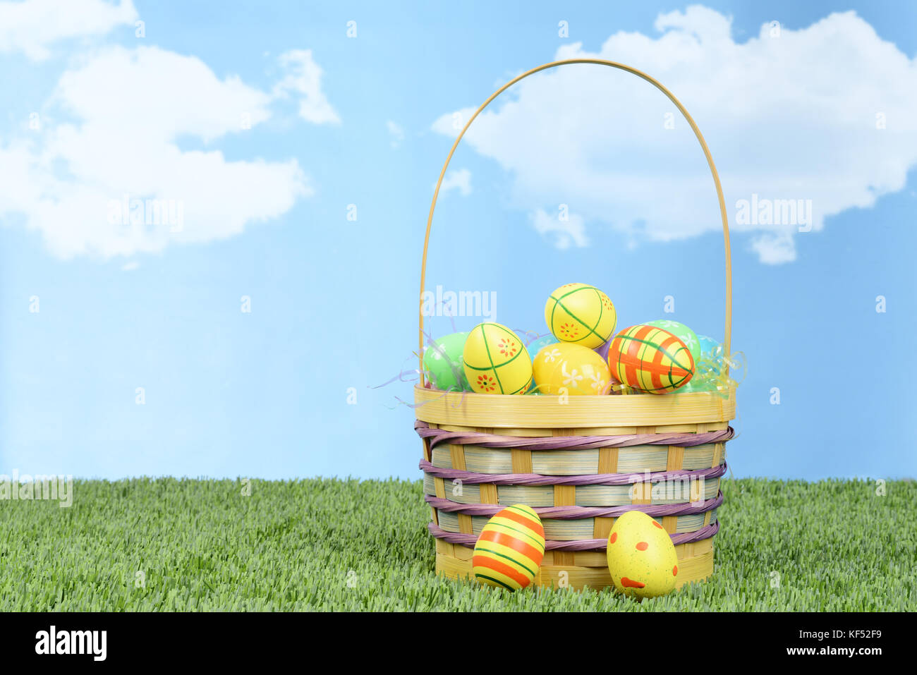 wicker basket full of colorful easter eggs Stock Photo - Alamy