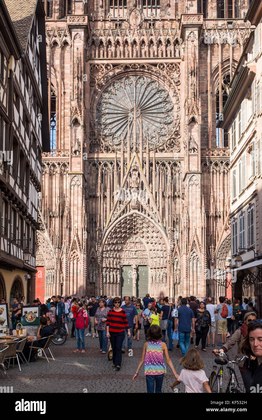 People walk down Rue Mercière towards Cathédrale Notre Dame de Strasbourg, France Stock Photo
