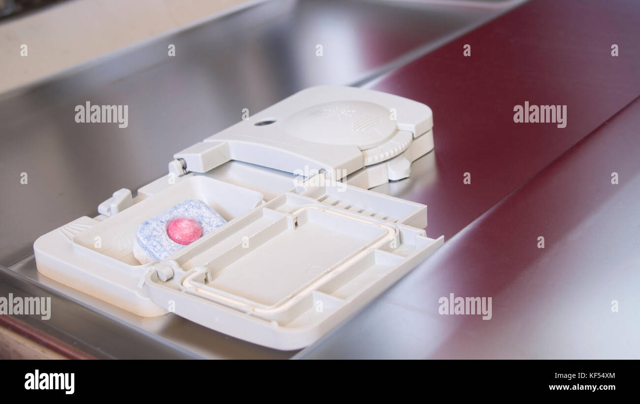 Put tablet detergent in the dishwasher Stock Photo Alamy