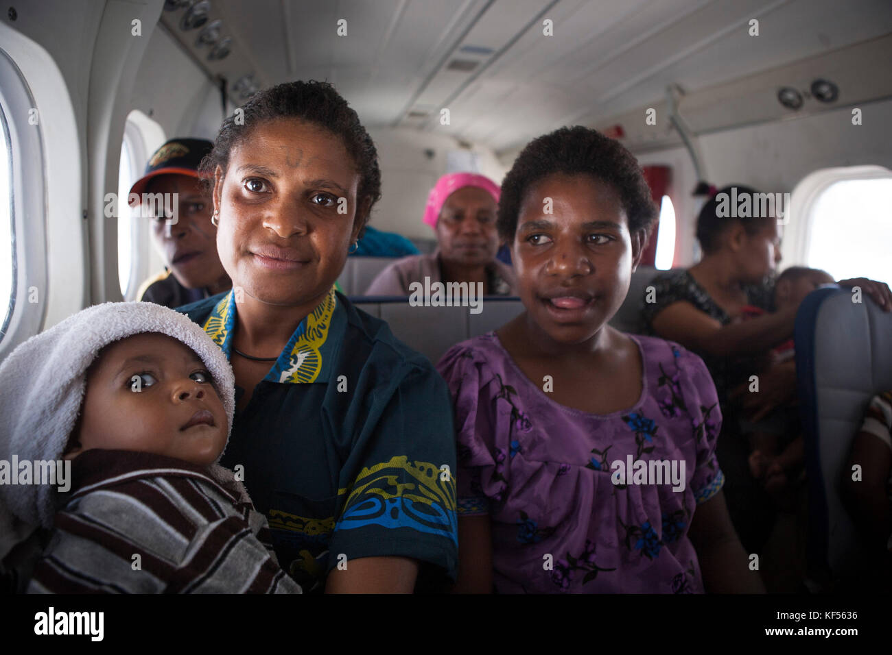 Family in a plane between Telefomin and Tari, Papua New Guinea Stock Photo
