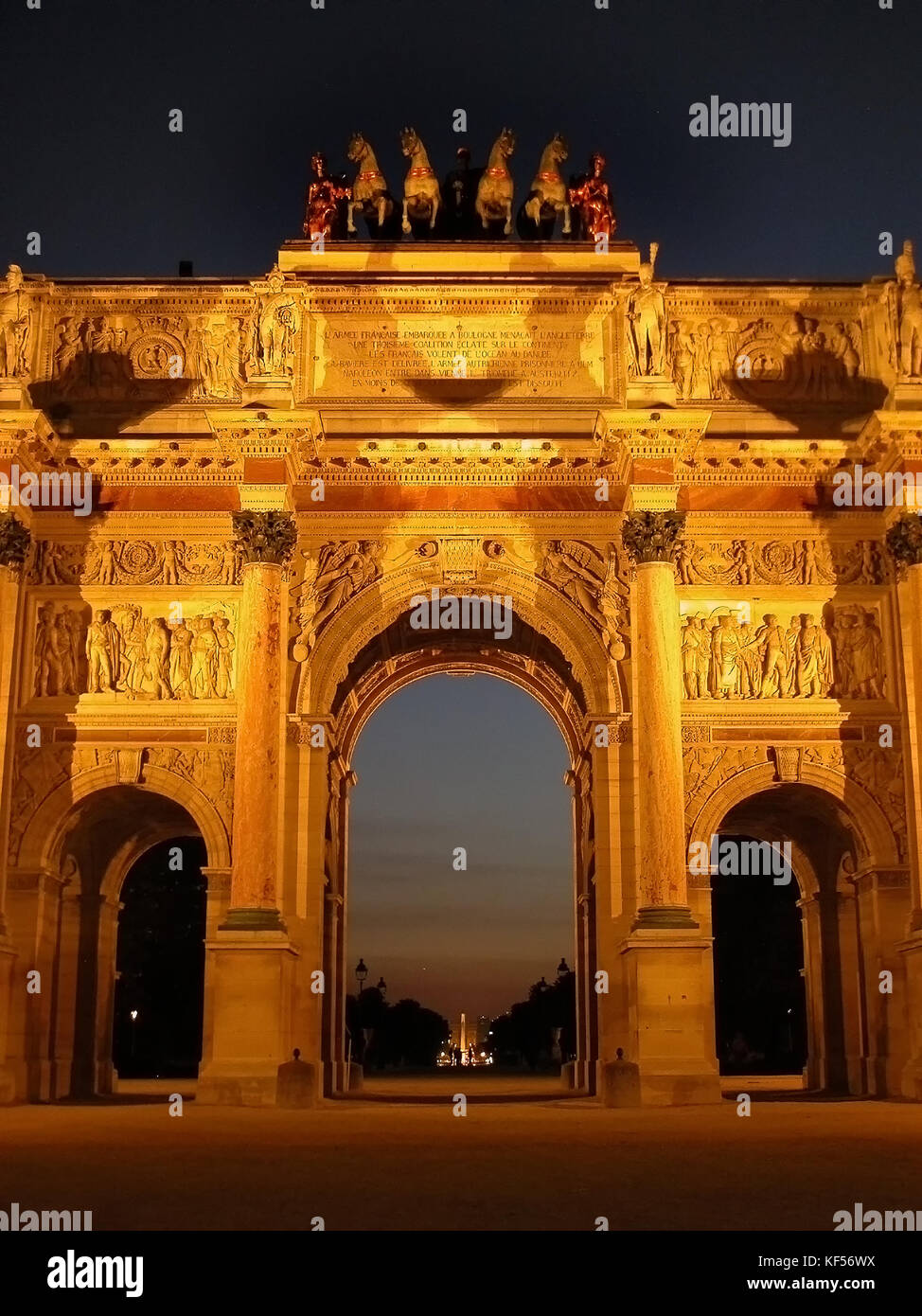 Arc de Triomphe du Carrousel illuminated at night looking up the Axe Historique, Paris, France Stock Photo