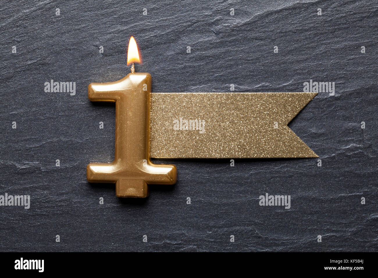 Gold number 1 celebration candle with glitter label Stock Photo