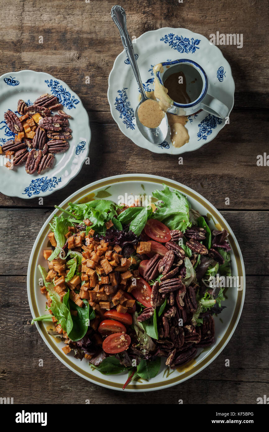 Mesclun salad with roasted sweet potatoes, toasted pecans, tomatoes and