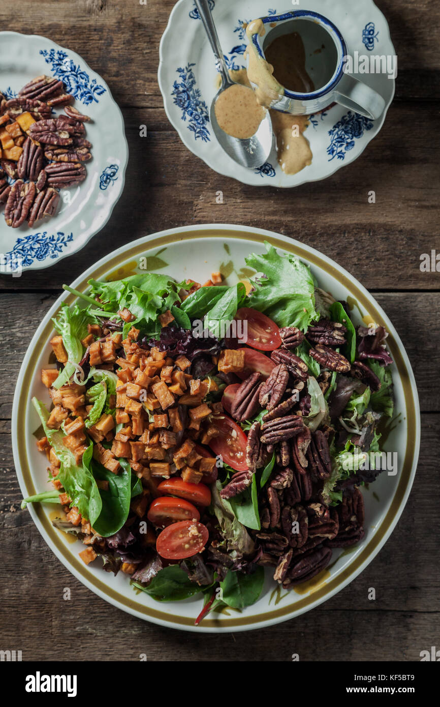 Mesclun salad with roasted sweet potatoes, toasted pecans, tomatoes and
