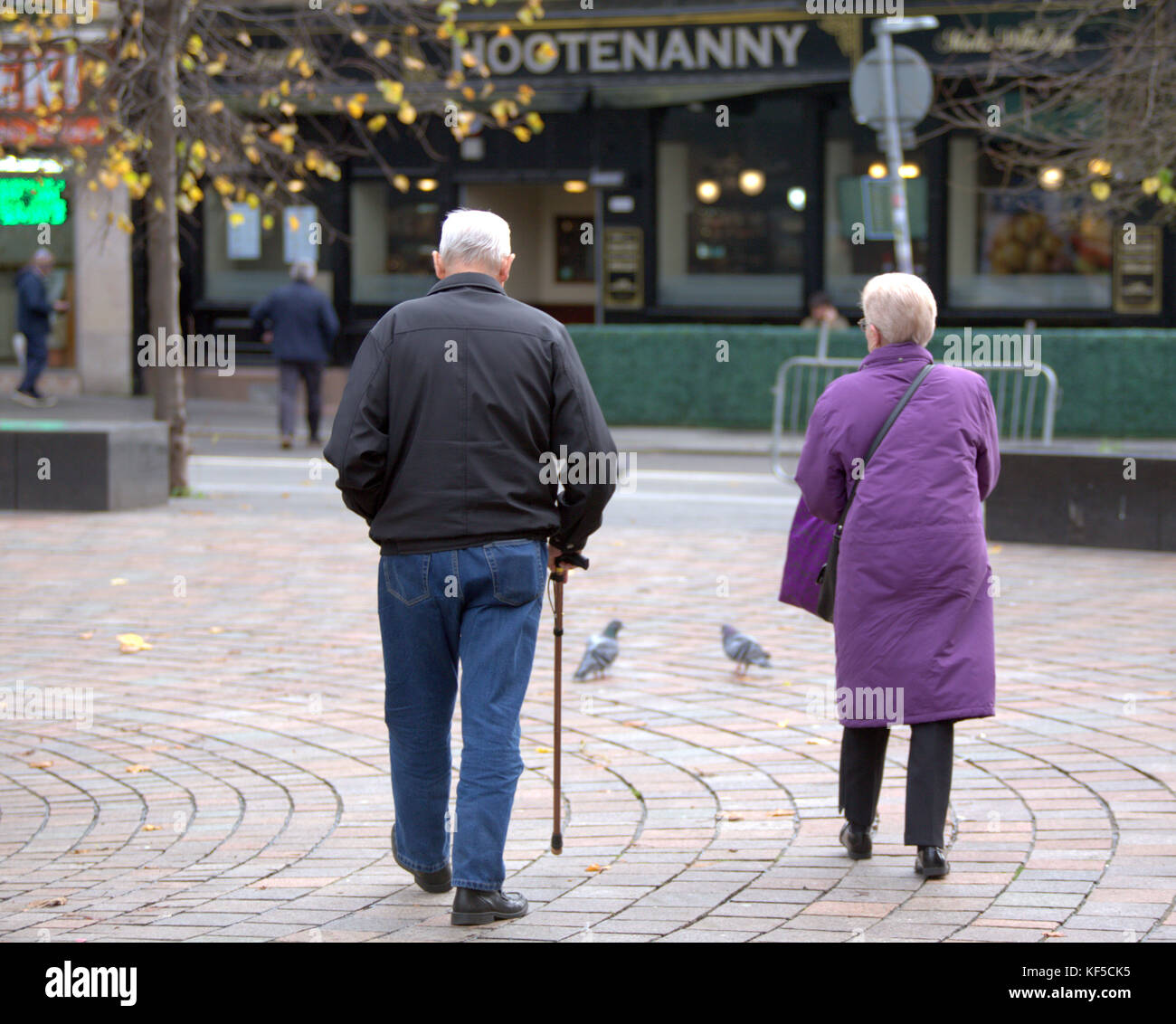 old senior couple husband and wife with walking stick seniors viewed from behind Stock Photo