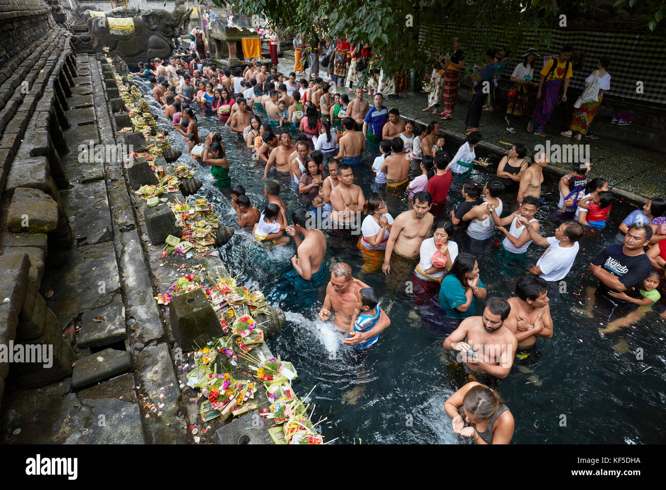 People waiting in line to make ritual purification in the holy spring. Tirta Empul Temple, Tampaksiring, Bali, Indonesia. Stock Photo