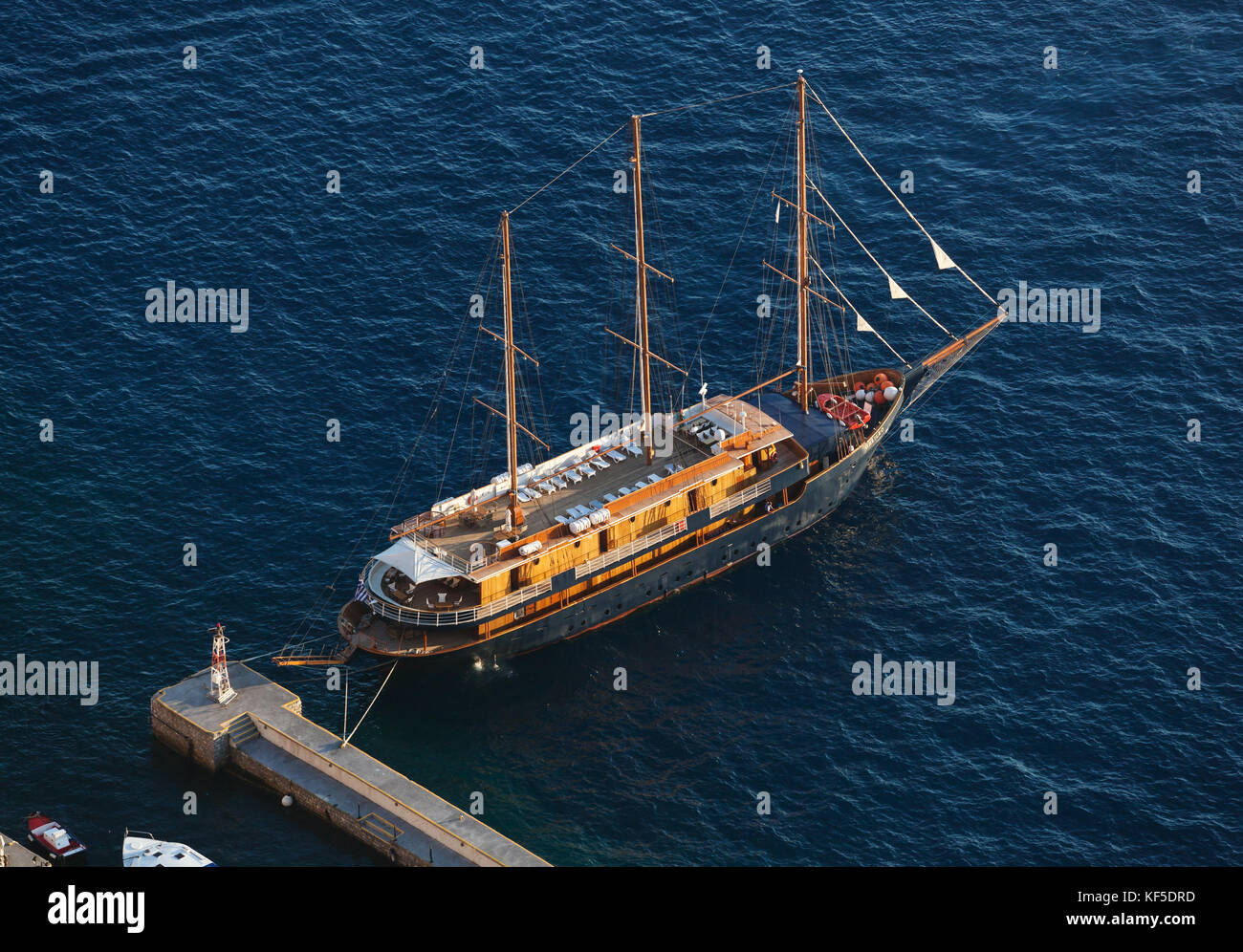 Santorini Island, Greece - July 19, 2012: Passenger ship in the old port of Fira early sunny morning. These ancient boats are used to make mini cruise Stock Photo