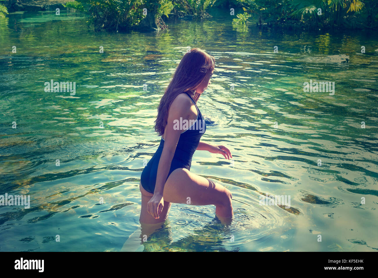 Beautiful teen girl in cenote of Riviera Maya with swimsuit Stock Photo