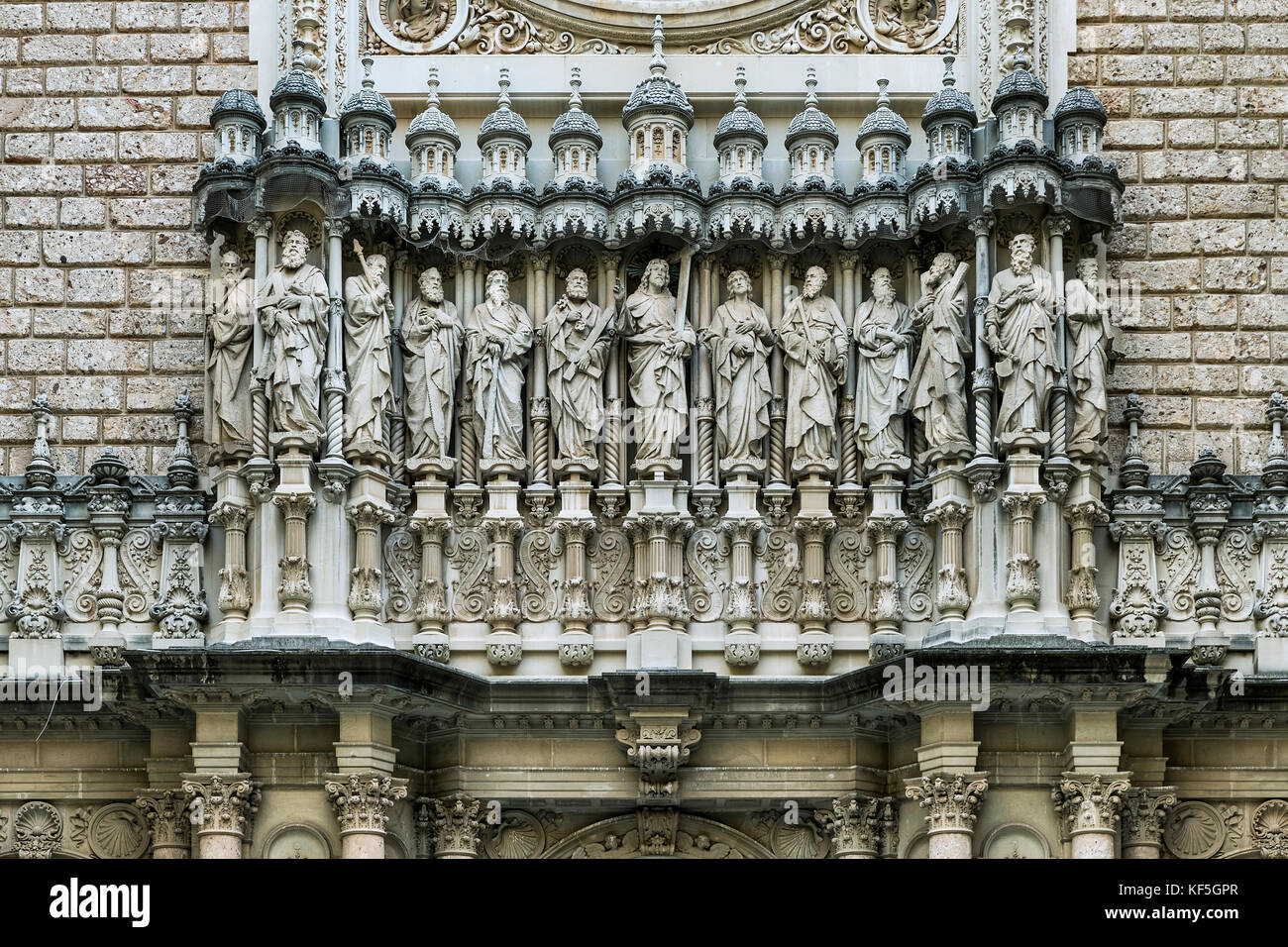 Exterior sculpture of Jesus and the twelve apostles, Santa Maria de Montserrat, Monistrol de Montserrat,  Catalonia, Spain. Stock Photo