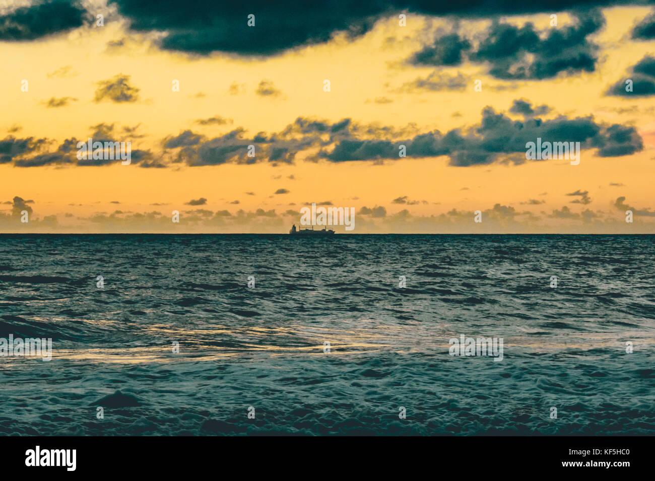 barge on the horizon at sunrise Stock Photo - Alamy