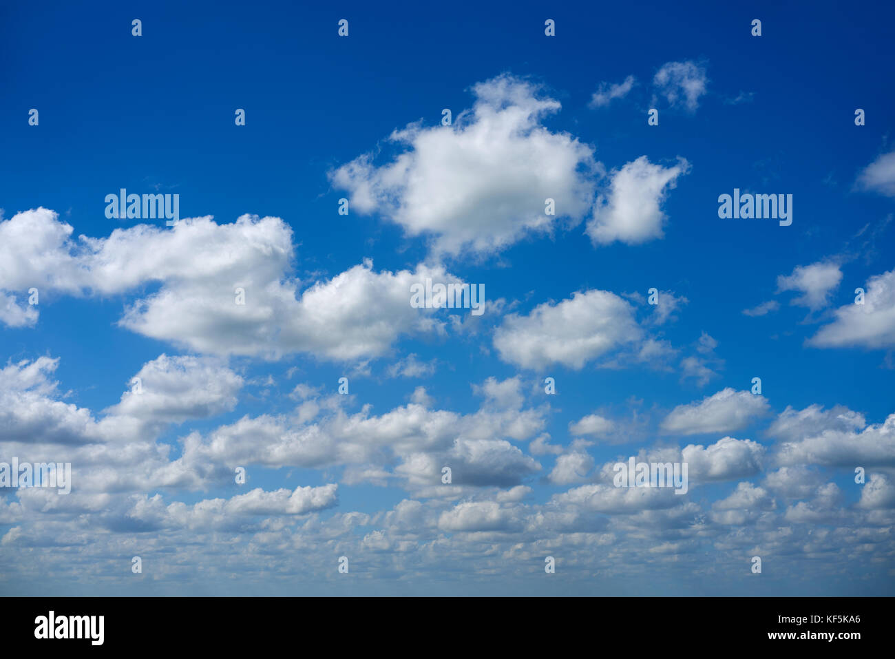 Blue summer sky white cumulus clouds background Stock Photo - Alamy