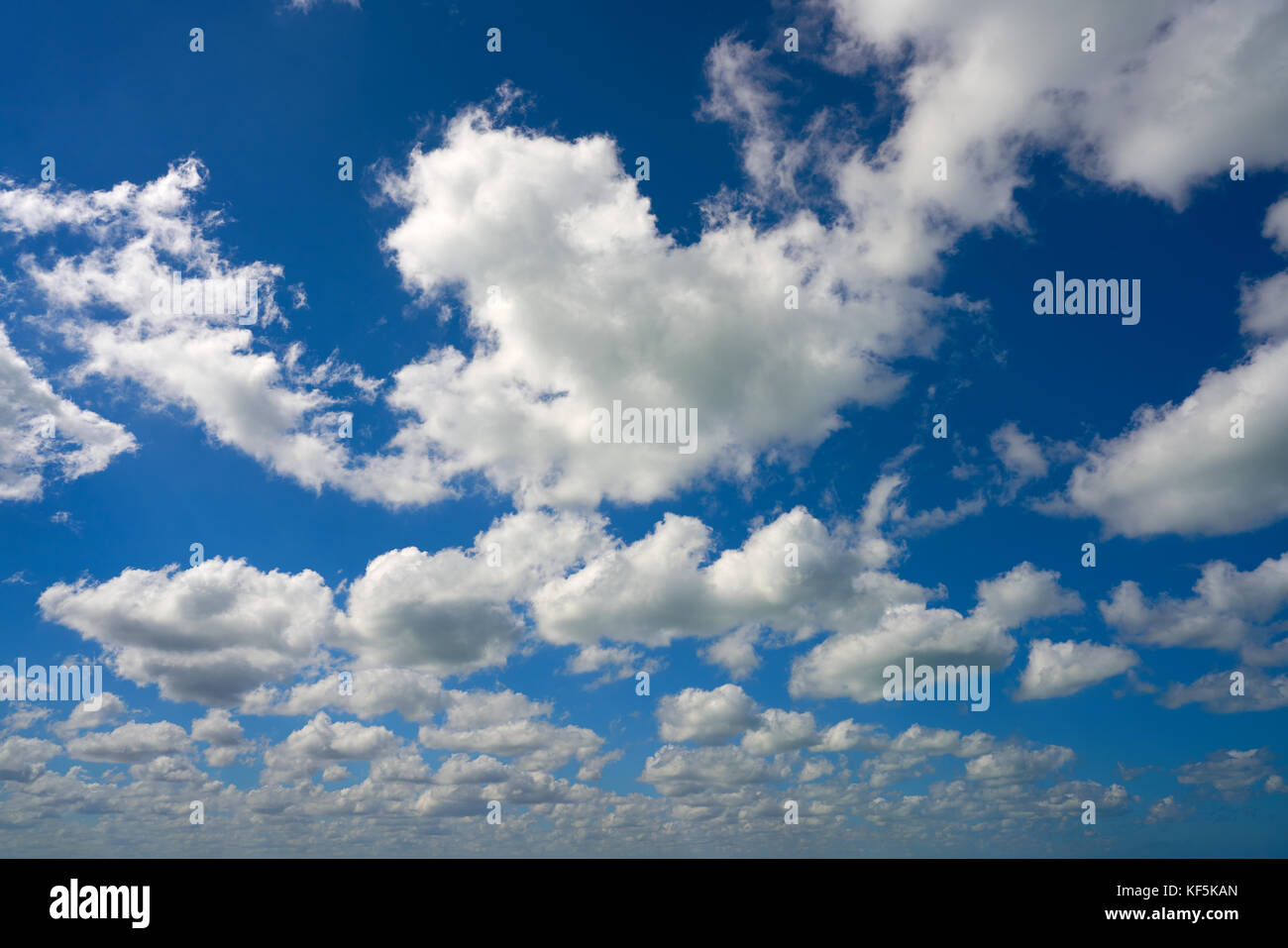 Blue summer sky white cumulus clouds background Stock Photo - Alamy
