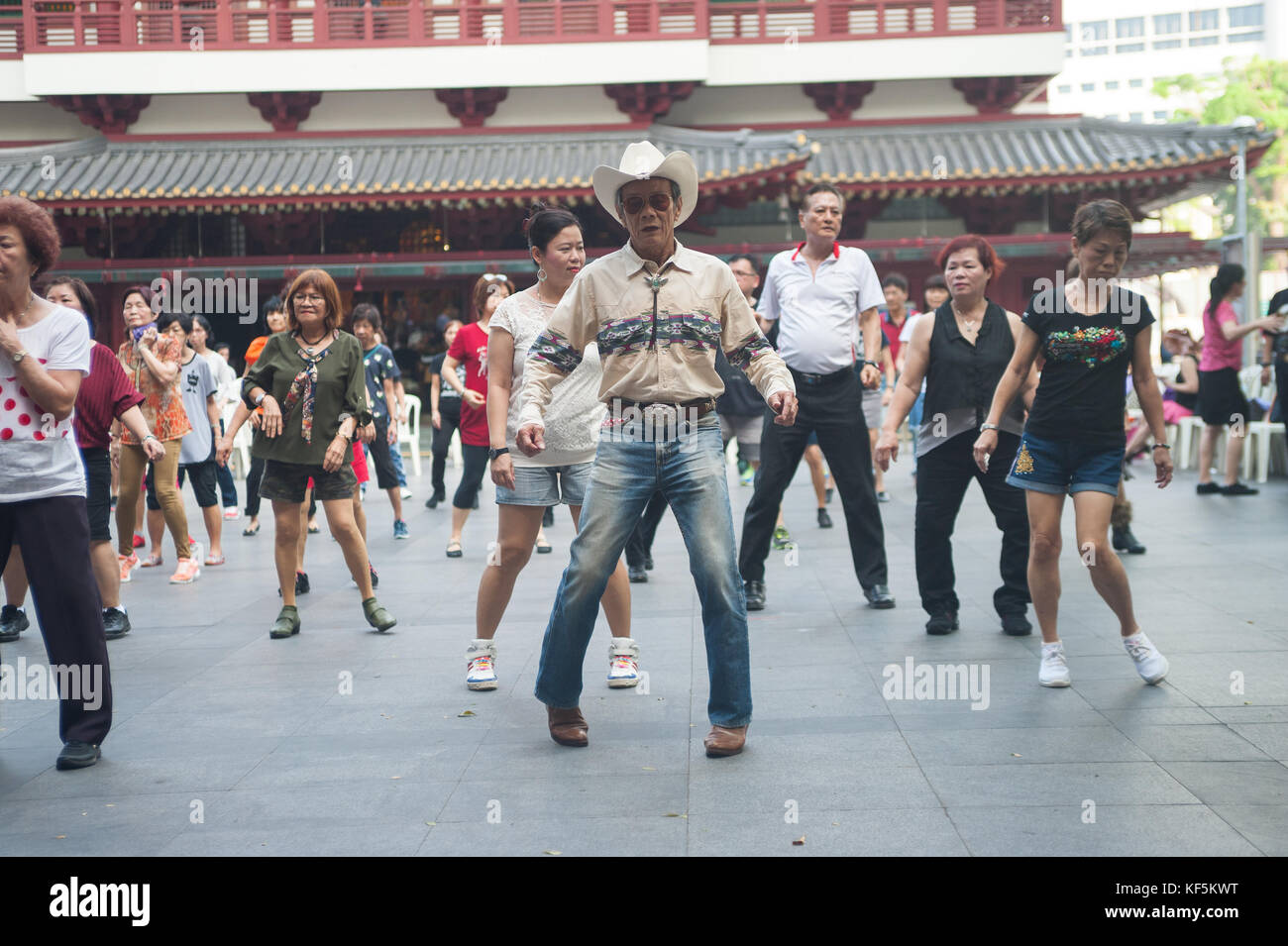 22.10.2017, Singapore, Republic of Singapore, Asia - A group of elderly people meet on Sundays for their line dance at a public square in Chinatown. Stock Photo