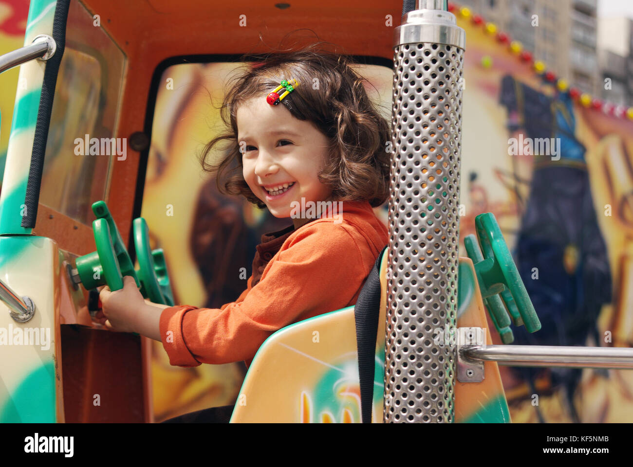 Cute little girl ride on a children's train and smiles happily Stock ...