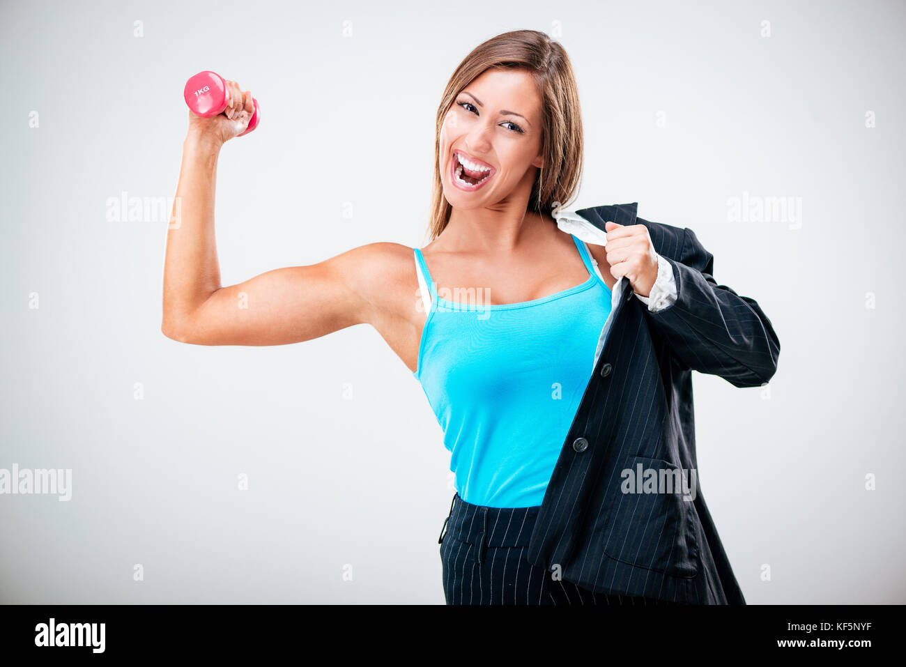 Multitasking businesswoman balancing life work and fitness. Stock Photo