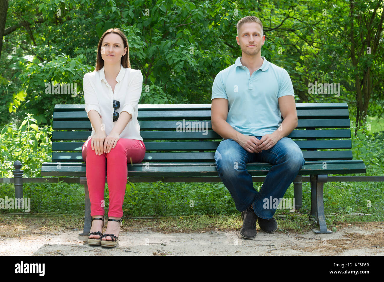 Shy Young Man And Woman  On First Date In Park Stock Photo