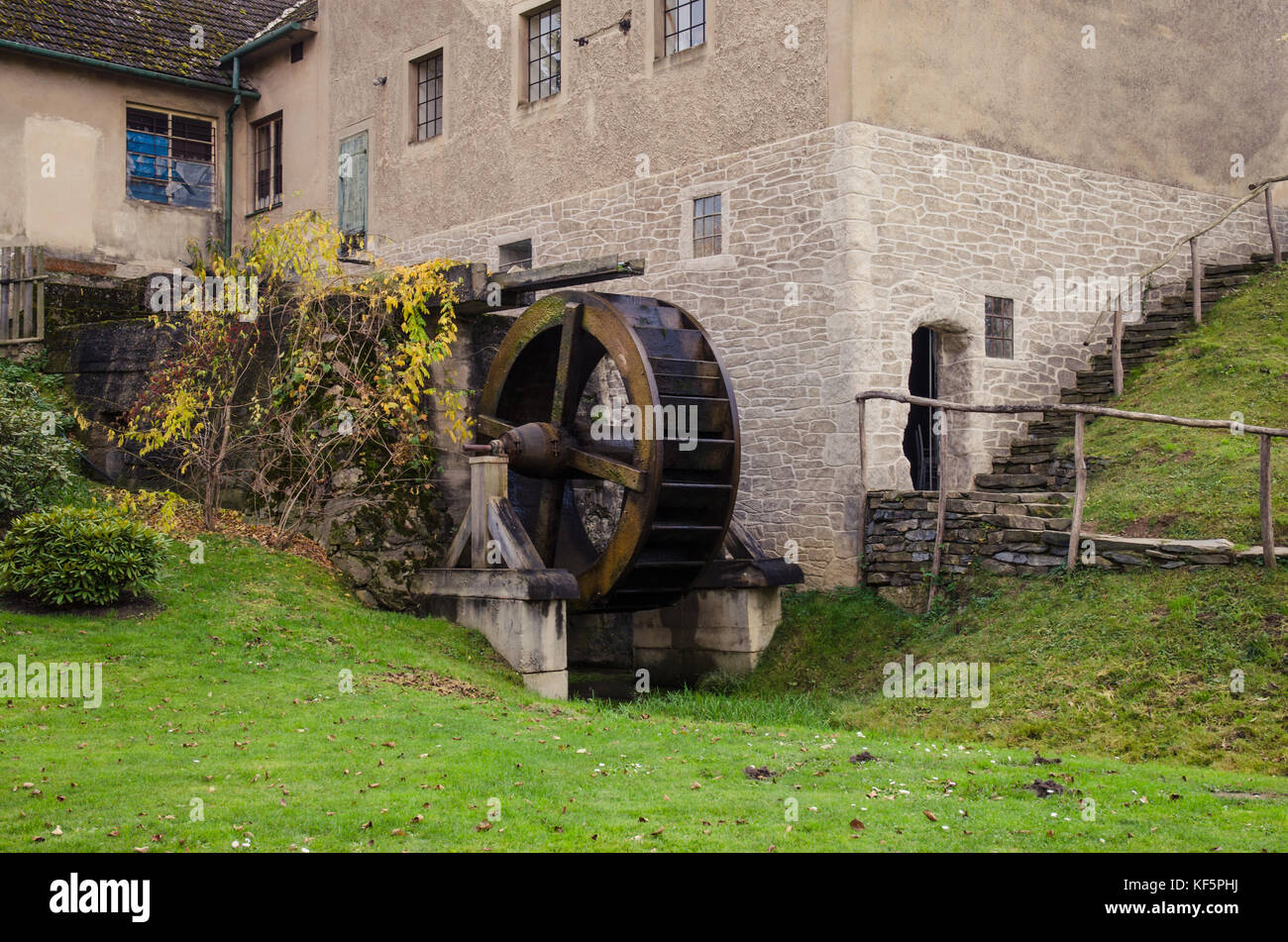 aged wooden water mill in beautiful scenery Stock Photo