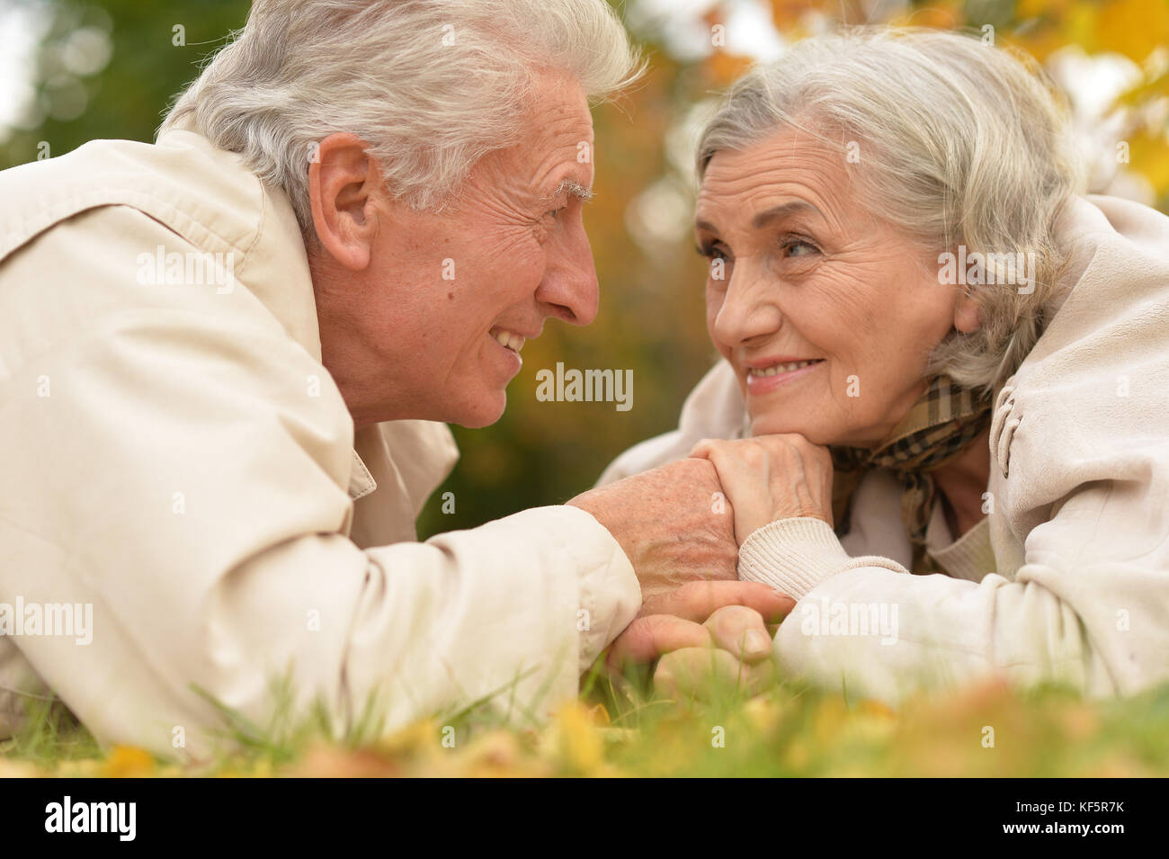couple in autumn park lying Stock Photo - Alamy