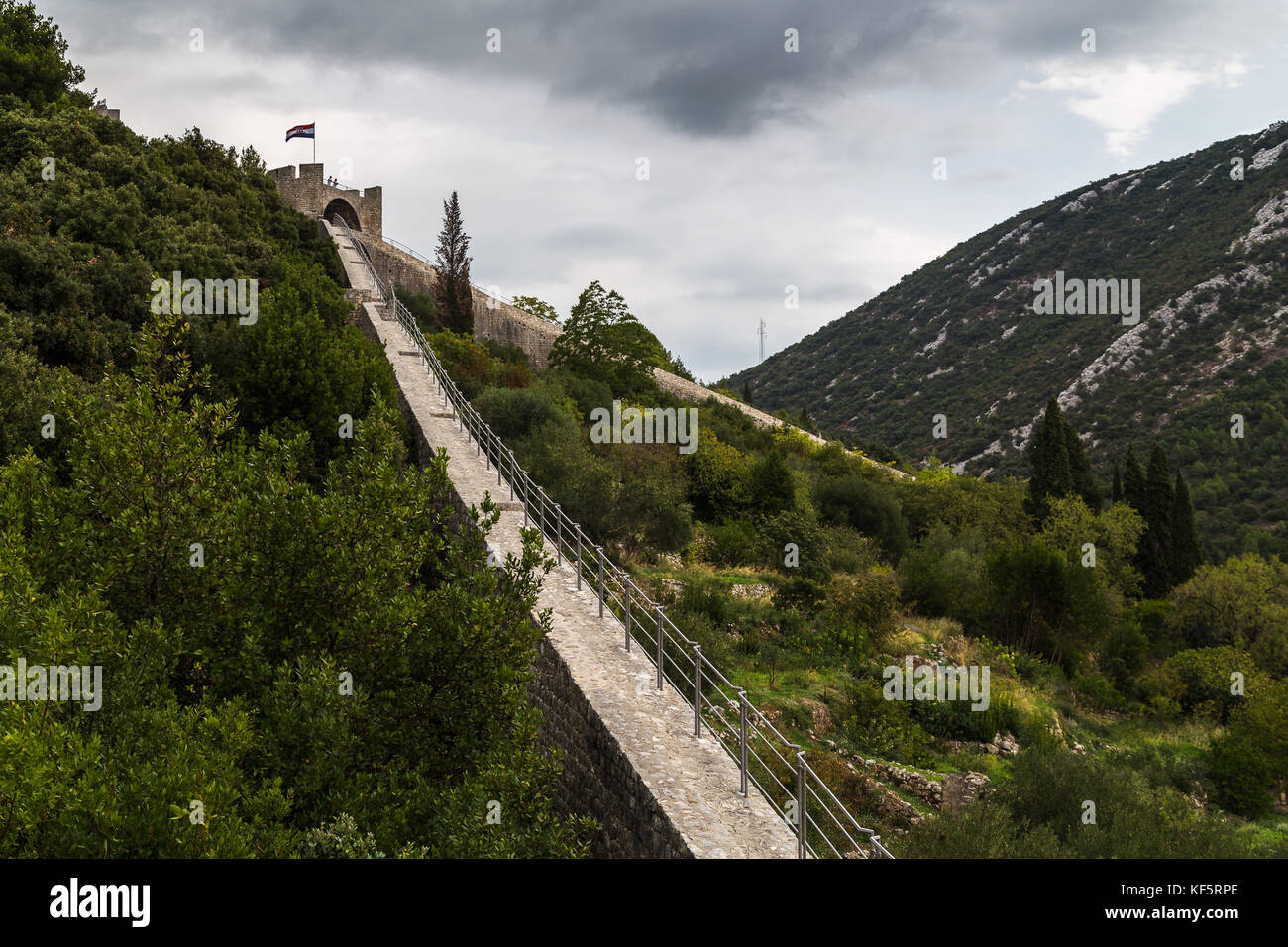Walking along the 5.5 kilometer wall of Ston (Croatia) which is the second longest in the world after the Great Wall of China. Stock Photo